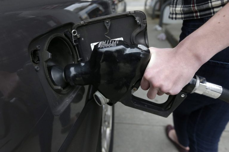 FILE - In this April 29, 2014 photo, a customer fills her car with fuel at a gas station, in Brookline, Mass. Gasoline prices are falling along with oil prices this summer because concerns of global supply disruptions have subsided somewhat despite continued violence in the Middle East. (AP Photo/Steven Senne, File)