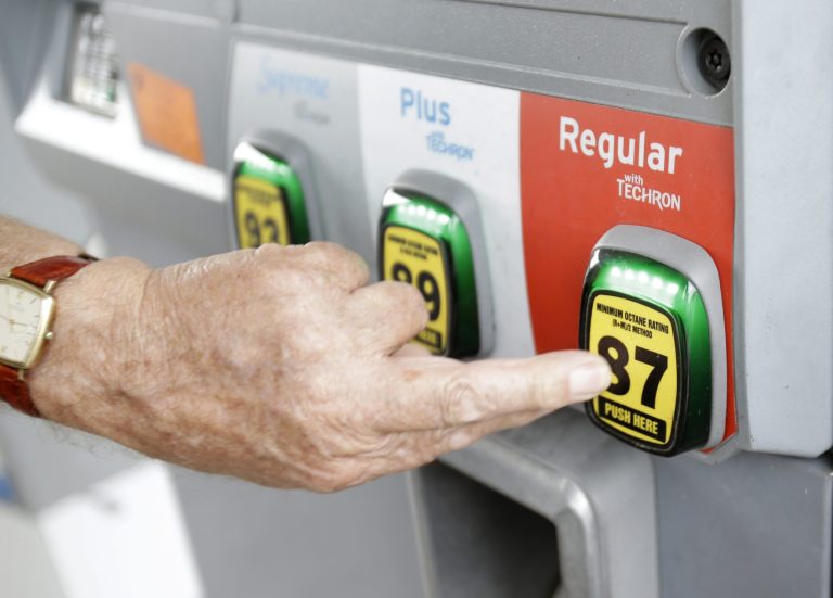 In this Wednesday, June 4, 2014 photo, Marty Mascio of Pembroke Pines, Fla., selects a grade of gasoline as he fills up his car at a Chevron station in Pembroke Pines. Violence in Iraq is pushing U.S. gasoline prices higher during a time of year they usually decline. The national average price of $3.67 per gallon is the highest price for this time of year since 2008, the year gasoline hit its all-time high. (AP Photo/Wilfredo Lee)
