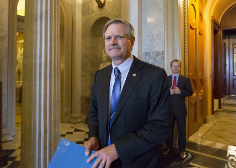Sen. John Hoeven, N.D., leaves the Senate chamber on Capitol Hill in Washington, Friday, June 21, 2013, after speaking on his amendment to the immigration reform bill. Hoeven and Sen. Bob Corker, R-Tenn., are pushing an amendment that insists on increased border security with an increase in Border Patrol agents and unmanned surveillance drones. (AP Photo/J. Scott Applewhite)