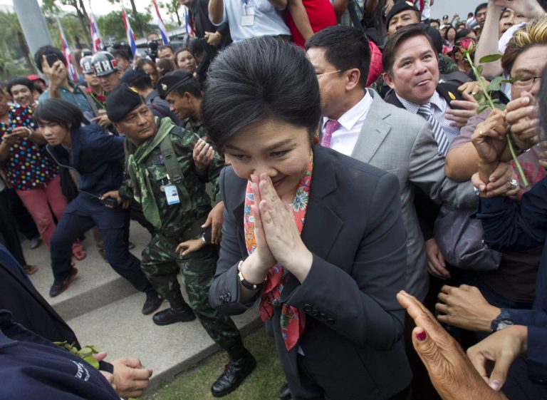 Thai Prime Minister Yingluck Shinawatra walk to meet  supporters in Bangkok, Thailand Wednesday, May 7, 2014. Yingluck and part of her Cabinet have been forced out of office by the Court ruling finding her guilty in an abuse of power case, pushing the country deeper into political turmoil. (AP Photo/Sakchai Lalit)