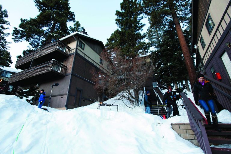 Members of the news media are shown outside a home, at left, in Big Bear, Calif., where two women were taken hostage by fugitive Christopher Dorner. Police scoured mountain peaks for days, using everything from bloodhounds to high-tech helicopters in their manhunt for Dorner, a revenge-seeking ex-cop. They had no idea he was hiding among them, possibly holed up in this vacation home across the street from their command post. (AP Photo/Nick Ut)