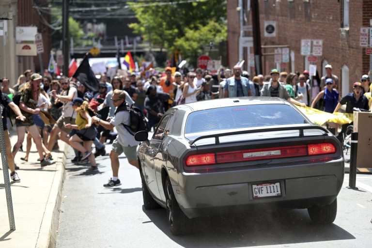 A vehicle drives into a group of protesters demonstrating against a white nationalist rally in Charlottesville, Va., Saturday, Aug. 12, 2017. The nationalists were holding the rally to protest plans by the city of Charlottesville to remove a statue of Confederate Gen. Robert E. Lee. There were several hundred protesters marching in a long line when the car drove into a group of them.