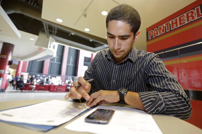 An applicant fills out a form during a 2014 job fair in Sunrise, Fla. More than 60 percent of CEOs surveyed by the Business Roundtable plan to expand payrolls this year. 