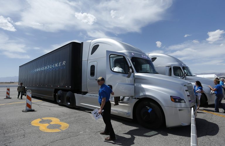 People load in to a Daimler Freightliner Inspiration self-driving truck for a demonstration Wednesday, May 6, 2015, in Las Vegas. (AP Photo/John Locher)
