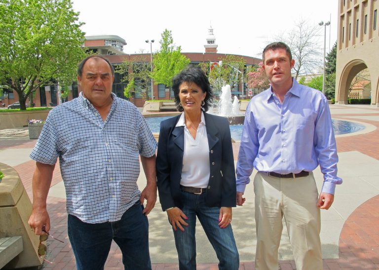 From left, Larry Harvey, Rhonda Firestack-Harvey, and Rolland Gregg stand in the plaza in front of the federal courthouse in Spokane, Wash. (AP Photo/Nicholas K. Geranios)