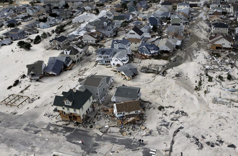   FILE - In an Oct. 31, 2012, file aerial photo, the destroyed and damaged homes are left in the wake of Superstorm Sandy in Ortley Beach, N.J. Researchers with the United States and British governments concluded Thursday Sept. 5, 2013, that climate change had made these events more likely: U.S. heat waves, Superstorm Sandy flooding, shrinking Arctic sea ice, drought in Europe's Iberian peninsula, and extreme rainfall in Australia and New Zealand. (AP Photo/Mike Groll, File)  