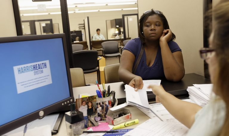 Lillian Ardon, right, helps Vanessa Danielle Cotton, left, with her Affordable Care Act marketplace application on Oct. 1 in Houston. (AP Photo/David J. Phillip)