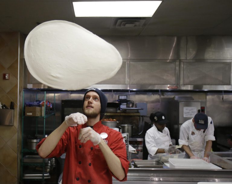 In this Thursday, March 27, 2014 photo, John Pittenger tosses up a pizza dough at the Whole Foods Market in Woodmere Village, Ohio. The Labor Department releases its May report on producer prices on Friday, June 13, 2014. (AP Photo/Tony Dejak)