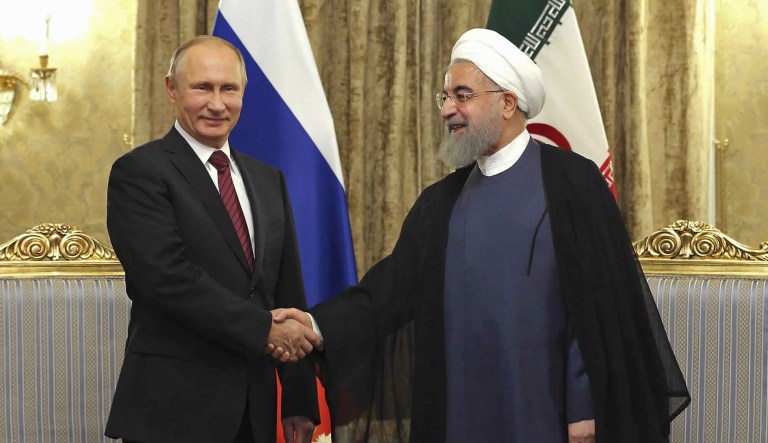 Iranian and Russian operations in Afghanistan also recall their cooperation in Syria, where they have fought to prop up Syrian President Bashar Assad. (Iranian Presidency Office via AP)