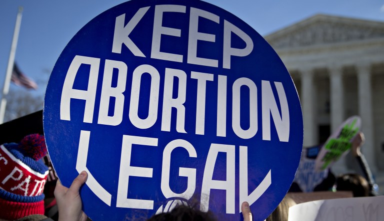 A demonstrator holds up a sign in support of abortion outside the U.S. Supreme Court in Washington, D.C., on Wednesday, March 2, 2016.