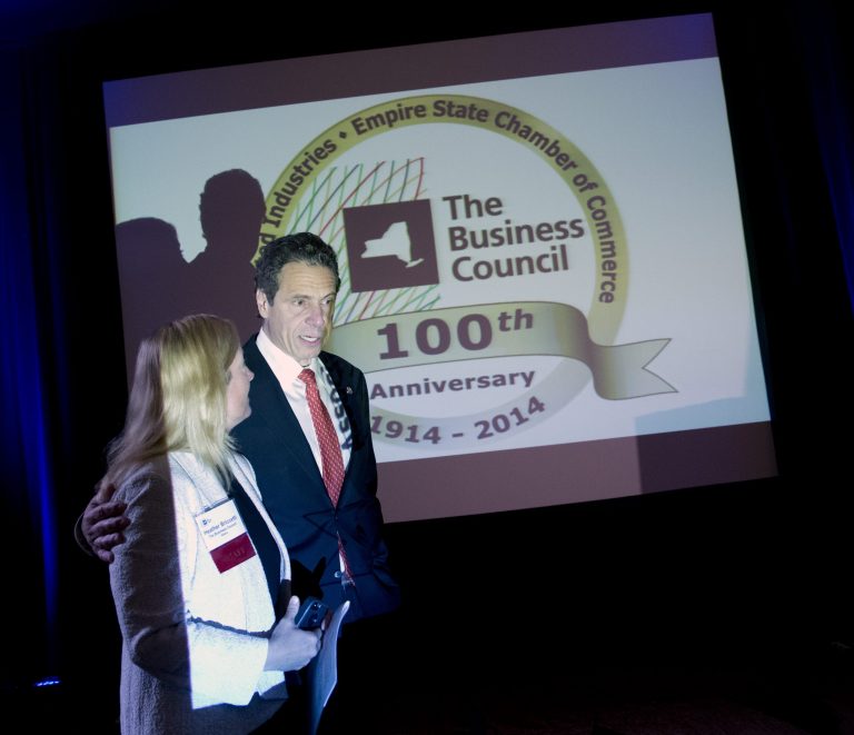 New York Gov. Andrew Cuomo, right, arrives to speak at the annual meeting of the Business Council of New York State with Heather Briccetti, president of the business council, at the Sagamore Resort on Friday, Sept. 19, 2014, in Bolton Landing, N.Y. (AP Photo/Mike Groll)