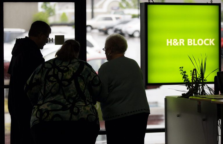 A customer, left, is helped at an H&R Block office in Nashville, Tenn., on Tuesday, April 17, 2012. (AP Photo/Mark Humphrey)
