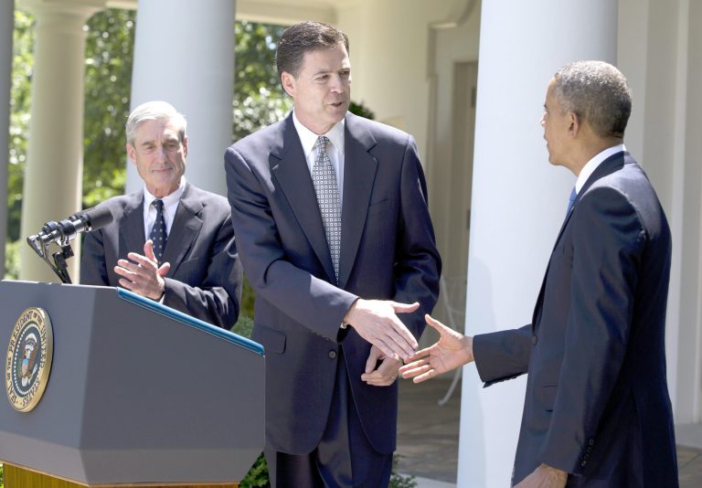 Evan Vucci/AP
President Obama shakes hands with James Comey, a senior Justice Department official under President George W. Bush, center, after announcing he will nominate Comey to replace Robert Mueller, left, as FBI directorin the Rose Garden of the White House on Friday.
