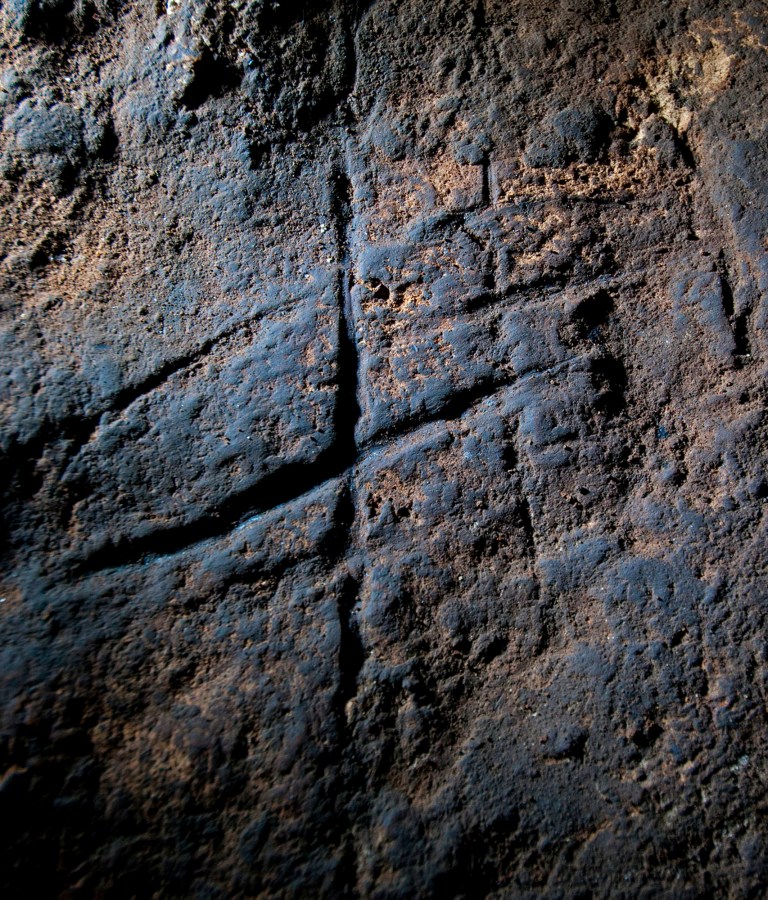 A Neanderthal rock engraving at Gorham's Cave in Gibraltar. The series of lines scratched into the rock could be proof that Neanderthals were more intelligent and creative than previously thought. (AP Photo/Courtesy of Stuart Finlayson via Journal)