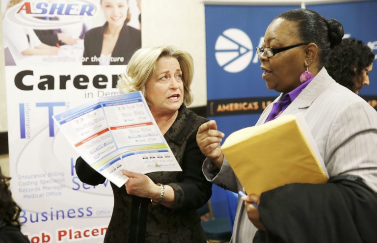 Recruiter Valera Kulow, left, speaks with job seeker Monic Spencer during a career fair in Dallas. (AP Photo/LM Otero, File)