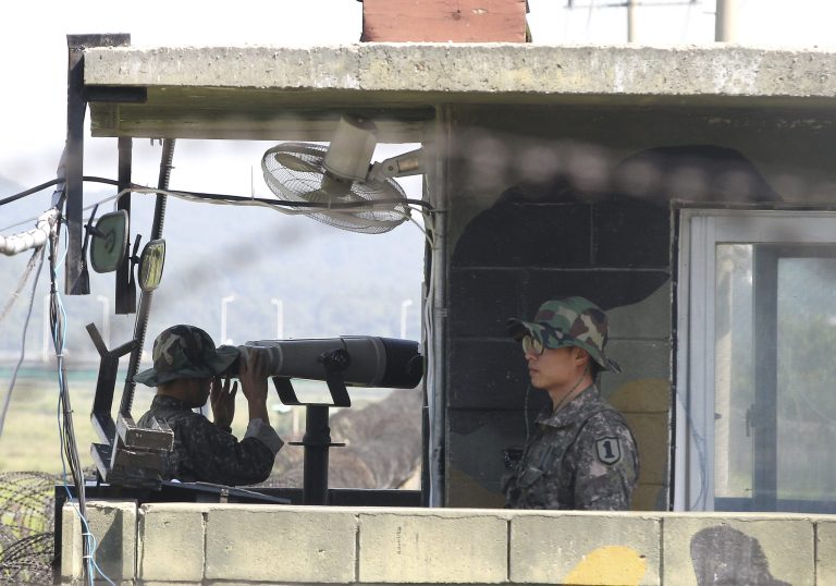 A South Korean army soldier looks through a pair of binoculars at a military check point in Paju near the border with North Korea, South Korea, Saturday, Sept. 6, 2014. North Korea on Saturday continued its string of rocket and missile firings, launching three short-range projectiles into the waters off its east coast ahead of a major holiday celebrated by both Koreas, a South Korean defense official said. (AP Photo/Ahn Young-joon)
