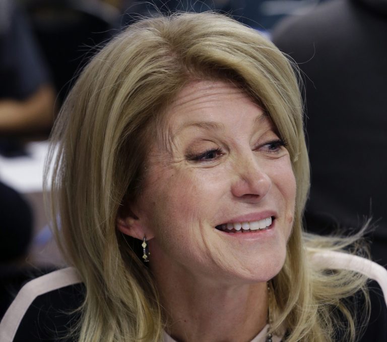 This March 4, 2014 file photo shows Texas Democratic gubernatorial candidate, State Sen. Wendy Davis visiting with volunteers at her campaign headquarters in Fort Worth, Texas. (AP Photo/LM Otero, File)