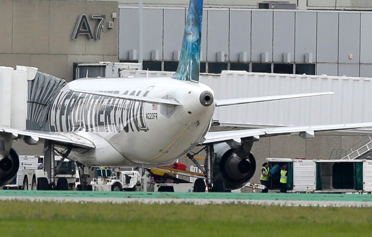 Two workers unload bags from the Frontier Airlines plane that Amber Joy Vinson flew from Cleveland to Dallas on Monday, at a terminal at Cleveland Hopkins International Airport Wednesday, Oct. 15, 2014, in Cleveland. Vinson is the second nurse to be diagnosed with Ebola at the Texas Health Presbyterian Hospital in Dallas. Ohio health officials aren't sure how many people came into contact with Vinson as she visited family in the Akron area days before being diagnosed with the disease. (AP Photo/Tony Dejak)