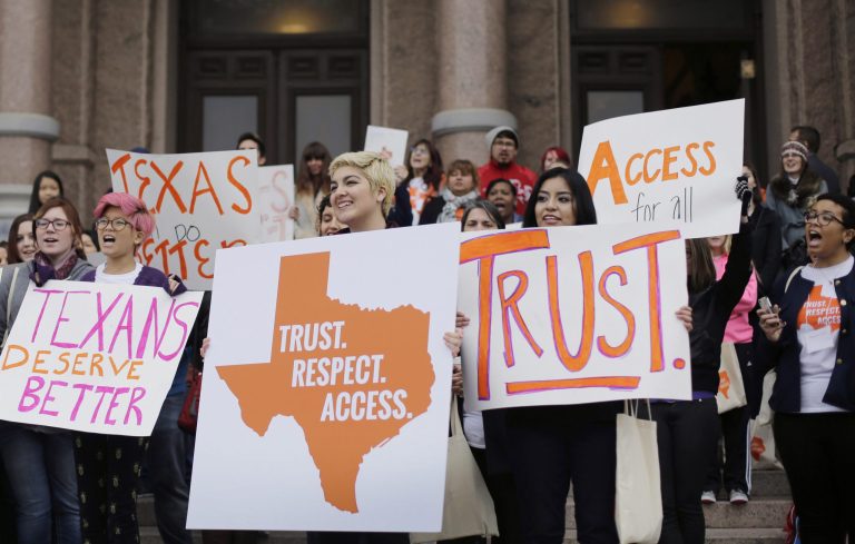In this Feb. 26, 2015 file photo, college students and abortion rights activists hold signs during a rally on the steps of the Texas Capitol, in Austin, Texas. The Supreme Court refused on Monday, June 29, 2015, to allow Texas to enforce restrictions that would force 10 abortion clinics to close. (AP Photo/Eric Gay, File)