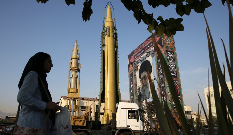 A Ghadr-H missile, center, a solid-fuel surface-to-surface Sejjil missile and a portrait of the Supreme Leader Ayatollah Ali Khamenei are displayed at Baharestan Square in Tehran, Iran, on Sunday, Sept. 24, 2017, for the annual Defense Week which marks the 37th anniversary of the 1980s Iran-Iraq war. (AP Photo/Vahid Salemi)