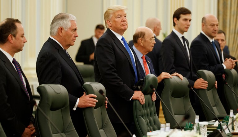 President Donald Trump waits for the beginning of a bilateral meeting with Saudi King Salam at the Royal Court Palace, Saturday, May 20, 2017, in Riyadh. From left are, White House chief of staff Reince Priebus, Secretary of State Rex Tillerson, Trump, Commerce Secretary Wilbur Ross, White House senior adviser Jared Kushner, and Chief Economic Adviser Gary Cohn. (AP Photo/Evan Vucci)