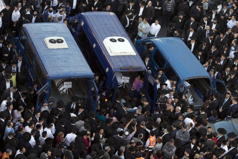 Mourners attend the funerals of Aryeh Kupinsky, Cary William Levine, and Avraham Goldberg, three of the four people killed in a shooting attack in a synagogue in Jerusalem, Tuesday, Nov. 18. (AP/Ariel Schalit)