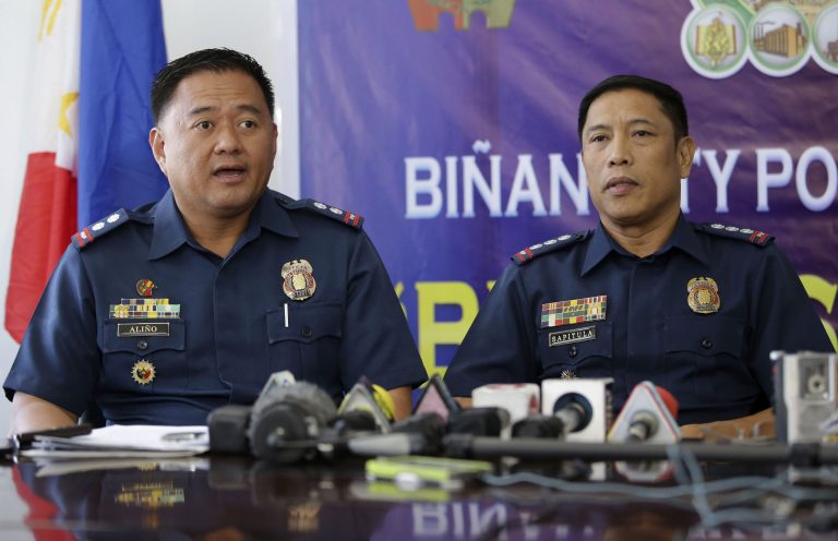 Philippine Police Superintendent Noel Calderon Alino, left, answers questions from reporters beside Senior Supt. Romulo Sapitula at a police station in Binan, Laguna province, south of Manila, Philippines on Monday, April 7, 2014. The police officials said Monday they have detained and filed a complaint of child trafficking against a vacationing Italian diplomat found at a resort south of Manila allegedly in the company of three street boys aged 9 to 12. (AP Photo/Aaron Favila)