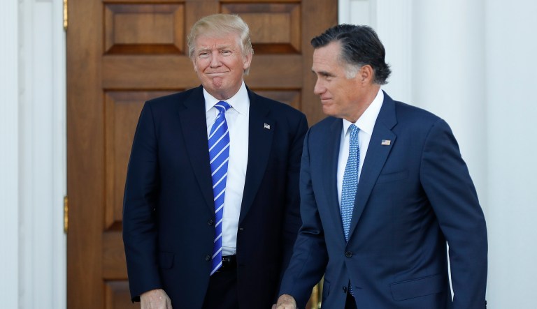 President-elect Donald Trump looks on as Mitt Romney walks from Trump National Golf Club Bedminster clubhouse in Bedminster, N.J., Saturday, Nov. 19, 2016, after meeting. 