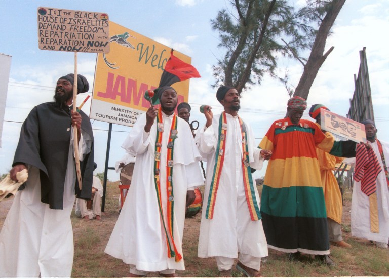 A group of rastafarians demonstrate at Norman Manley airport in Kingston, Jamaica, Monday, Feb.18, 2002, demanding compensation to those who suffered during slavery and repatriation to Africa. (AP Photo/Collin Reid)