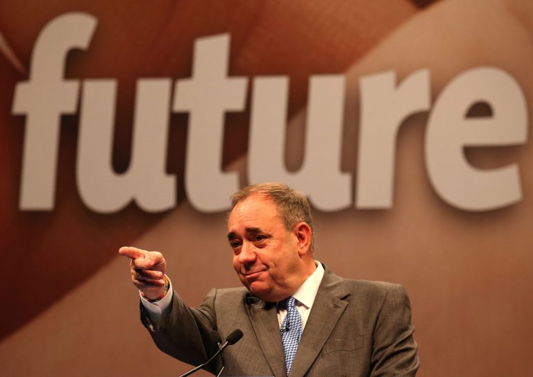 Scottish First Minister Alex Salmond addresses an audience of international journalists exactly 17 years since the country voted Yes to devolution at the Edinburgh International Conference Centre, Thursday, Sept. 11, 2014. In a blow to the Scottish independence campaign, top financial groups including the Royal Bank of Scotland and Lloyds Banking Group say they will move headquarters to England should Scots vote to break away from the United Kingdom. RBS, which has been based in Scotland since 1727, said Thursday it has drawn up contingency plans because of uncertainties that could hurt its business and customers should Scots vote to become independent next week. (AP Photo/PA, Andrew Milligan) UNITED KINGDOM OUT, NO SALES, NO ARCHIVE