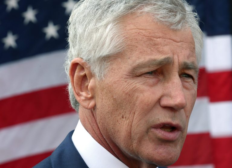 In this Tuesday, Dec. 10, 2013 photo, U.S. Secretary of Defense Chuck Hagel, speaks with reporters at the Al Udeid air base in Qatar. Hagel ended his six day trip in Qatar, meeting with the Emir, military officials, and visiting with US Troops stationed there. (AP Photo/Mark Wilson, Pool)