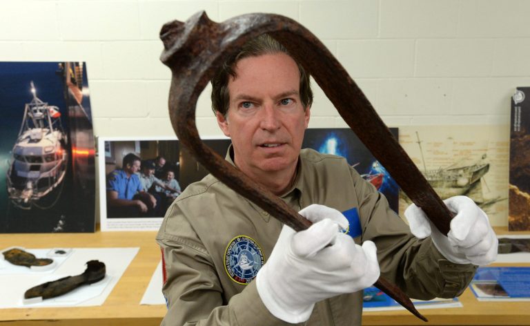 John Geiger, president of the Royal Canadian Geographical Society, holds an iron fitting from a Royal Navy ship, identified as a davit,  Tuesday, Sept. 9, 2014, in Ottawa. The artifact is being noted as the key piece of evidence that led to the discovery of a ship believed to be one of two fabled British explorer ships the Franklin Expedition. THe HMS Erebus and HMS Terror disappeared in the Arctic more 160 years ago. (AP Photo/The Canadian Press, Sean Kilpatrick)
