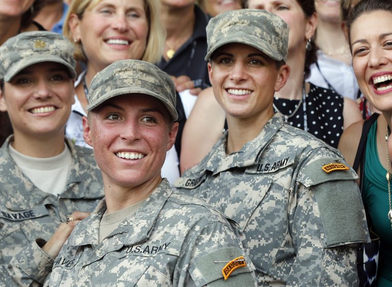 U.S. Army First Lt. Shaye Haver, center, and Capt. Kristen Griest, right, pose for photos with other female West Point alumni after an Army Ranger school graduation ceremony, Friday, at Fort Benning, Ga. (AP Photo/John Bazemore)