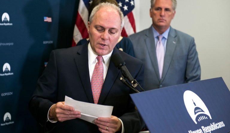 House Majority Whip Steve Scalise accompanied by House Majority Leader Kevin McCarthy reads a letter from a constituent concerning healthcare. Voters are split on how the government should require coverage for pre-existing conditions. (AP Photo/Cliff Owen)