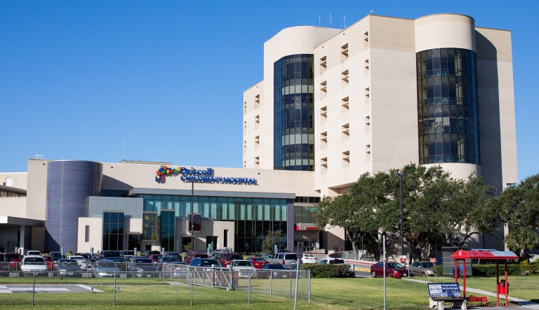 In this Wednesday, Oct. 25, 2017 photo, vehicles are parked outside Driscoll Children's Hospital, in Corpus Christi, Texas. United States Customs and Border Protection agents on Wednesday placed an undocumented 10-year-old girl with cerebral palsy in the back of an ambulance to transfer her from the hospital to a children's facility in San Antonio for emergency gallbladder surgery. Immigration advocates are protesting the case and say Border Patrol should show more discretion in the cases of sick children who are in the U.S. illegally but need medical treatment. (Courtney Sacco/Corpus Christi Caller-Times via AP)