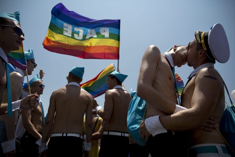 Israeli dancers kiss each other during the annual Gay Pride Parade on a street of Tel Aviv, Israel, Friday, June 13, 2014. Shirtless Israeli men, colorfully dressed drag queens and others partied Friday through central Tel Aviv as it celebrates the week-long event that supports lesbian, gay, bisexual and transgender people and their supporters, also known as the LGBT community. (AP Photo/Oded Balilty)