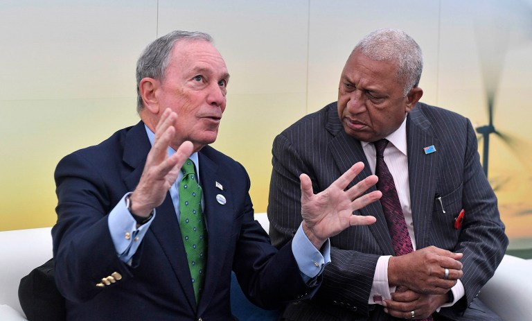 Former New York Mayor and billionaire Michael Bloomberg, left, speaks with Fiji prime minister and COP president Frank Bainimarama in the U.S. Climate Action Center at the COP 23 Fiji UN Climate Change Conference in Bonn, Germany. (AP Photo/Martin Meissner)