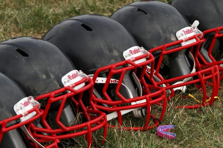 FILE - This Aug. 4, 2012 file photo shows new football helmets that were given to a group of youth football players from the Akron Parents Pee Wee Football League, in Akron, Ohio. It's not just football. A new report says too little is known about concussion risks for young athletes, and it's not clear whether better headgear is an answer. The panel stresses wearing proper safety equipment. But it finds little evidence that current helmet designs, face masks and other gear really prevent concussions, as ads often claim.  (AP Photo/Gene J. Puskar, File)