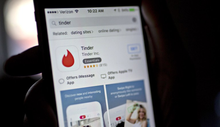 The download landing page for Tinder, a dating application, is displayed on an iPhone in Washington.