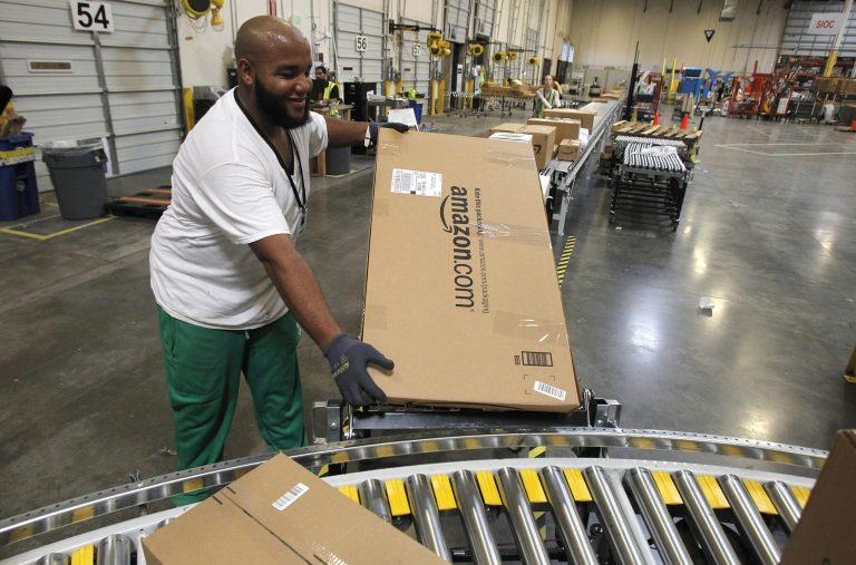 In this Nov. 11, 2010 photo, Leacroft Green places a package to the correct shipping area at an Amazon.com fulfillment center, in Goodyear, Ariz. (AP File)