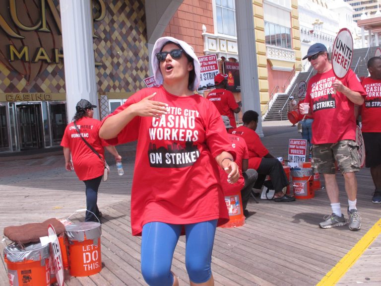Striking union members bang on plastic buckets outside the trump Taj Mahal casino in Atlantic City N.J. during a strike Tuesday July 5, 2016. Presumptive Democratic presidential nominee Hillary Clinton is to visit Atlantic City on Wednesday to bash Donald Trump's record of running casinos here in the 1908s and 1990s, but the presumptive Republican presidential nominee hasn't owned the Taj Mahal for years; it now belongs to his friend and fellow billionaire Carl Icahn. (AP Photo/Wayne Parry)