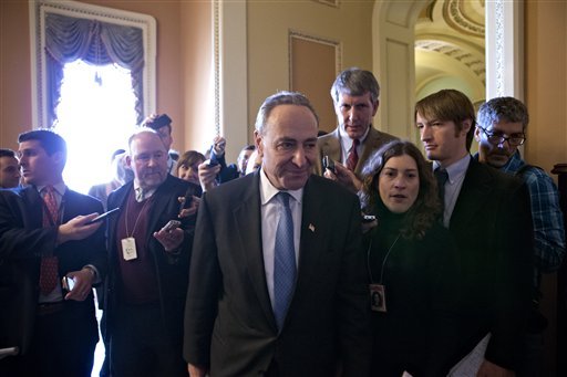 With reporters looking for updates, Sen. Charles Schumer, D-N.Y., retreats to a closed-door caucus with fellow Democrats as the Senate leadership works to negotiate a legislative path to avoid the so-called 