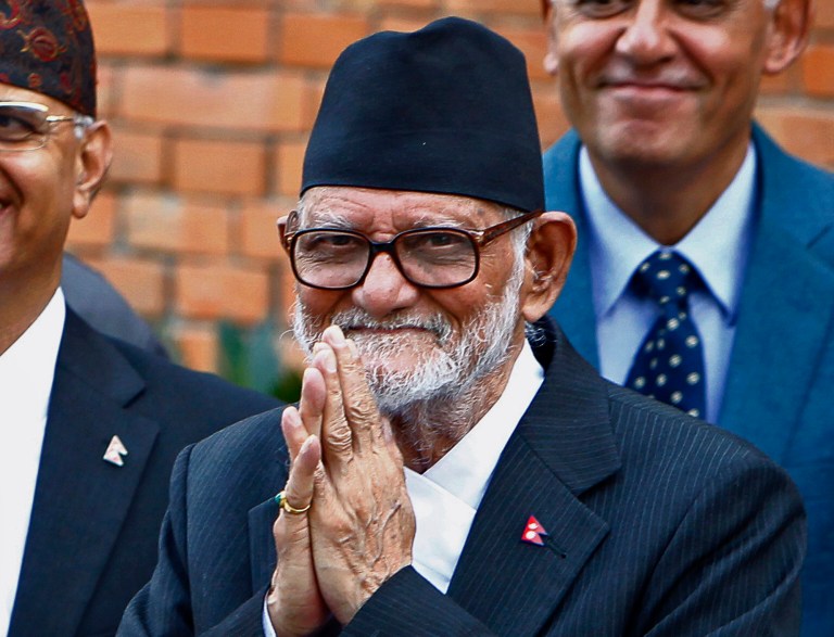Myanmarâs pro-democracy leader Aung San Suu Kyi, left, and Nepalâs Prime Minister Sushil Koirala greet journalists at Koirala's residence in Katmandu, Nepal, Friday, June 13, 2014. A parliamentary committee has voted against changing a clause in Myanmar's Constitution that bars opposition leader Suu Kyi from becoming president, in a setback to her hopes of leading the Southeast Asian nation. Suu Kyi arrived in Nepal Friday to attend a democracy conference, meet top political leaders and visit Buddhist pilgrimage sites. (AP Photo/Niranjan Shrestha)