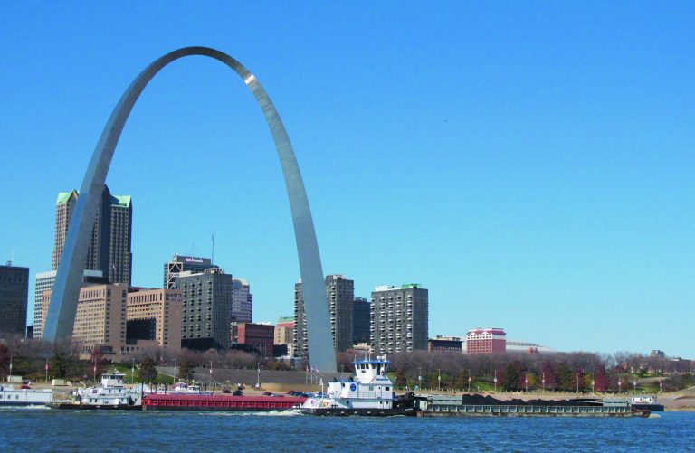 FILE - In this Nov. 12, 2012 file photo, two barges head north on the Mississippi River past St. Louis, as seen from East St. Louis, Ill. The Army Corps of Engineers has begun reducing the flow from a Missouri River reservoir, a move expected to worsen low water conditions on the Mississippi River and potentially halt barge traffic at St. Louis within weeks. (AP Photo/Jim Suhr, File)