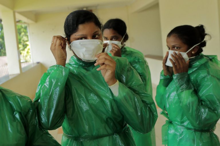 Sri Lankan health workers wear protective gear as they attend a preparedness program for Ebola at the Infectious Disease Hospital for fever in Colombo, Sri Lanka, Tuesday, Oct.28, 2014. (AP Photo/Eranga Jayawardena)