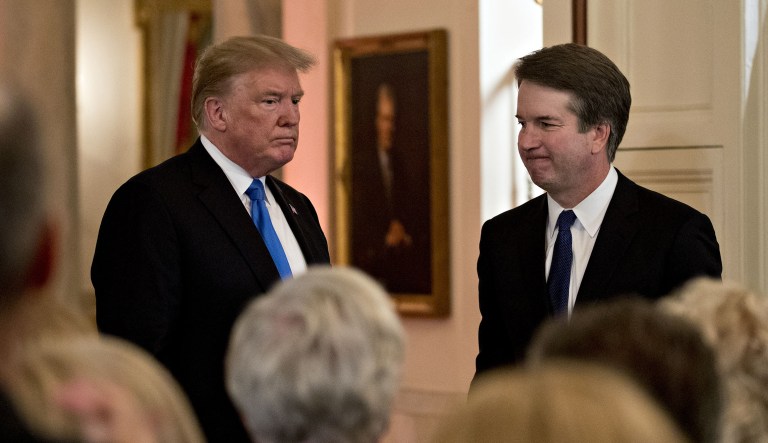 Brett Kavanaugh, appeals court judge, stands after being nominated as an associate justice of the Supreme Court by President Trump, left, during a ceremony in the East Room of the White House.