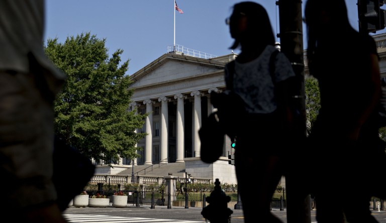 Pedestrians walk near the U.S. Treasury building in Washington, D.C.