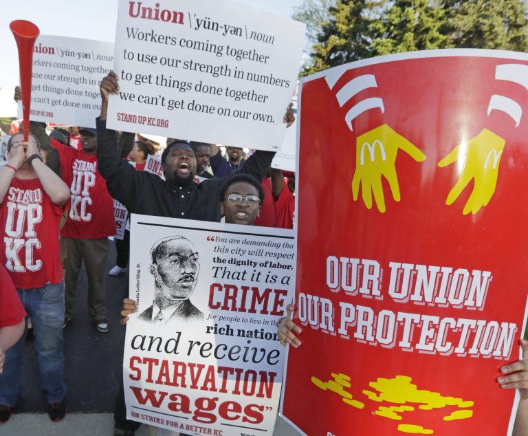 Hundreds of workers, organizers, and supporters gather outside of the McDonald's Corporation Thursday, May 22, 2014, in Oak Brook, Ill., protesting for a $15 an hour wage and the right to unionize. The group gathered outside the entrance as the company held the annual shareholders meeting. (AP Photo/M. Spencer Green)