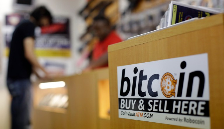 Bitcoin's value dipped slightly on Wednesday afternoon, according to tracking service Coindesk, paring 12 months of gains that had taken its value to $14,855 as both the Chicago Mercantile Exchange and the CBOE Futures Exchange offered futures contracts in it. (AP Photo/Eric Gay)