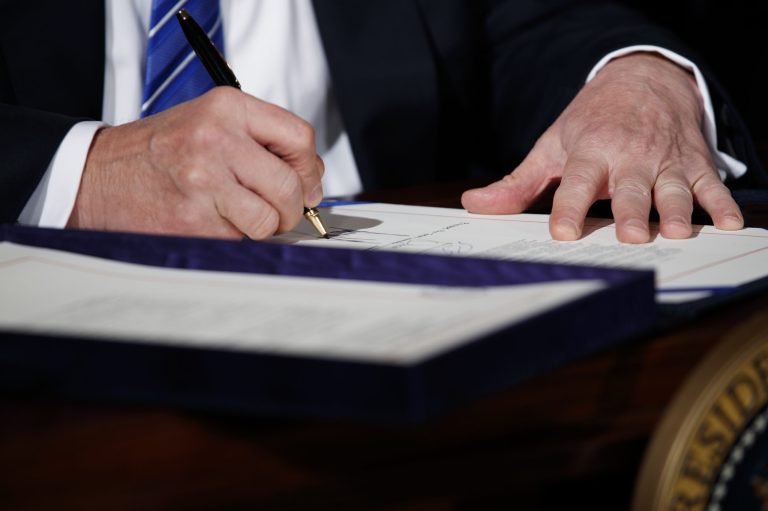 President Donald Trump signs the 